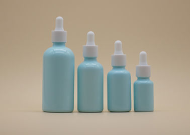 Il contagoccia blu dell'olio essenziale della glassa imbottiglia la bottiglia ceramica bianca per cura personale